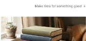 A stack of books beside a cup
